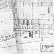 a rolled up blueprints on a table - progetto costruzioni